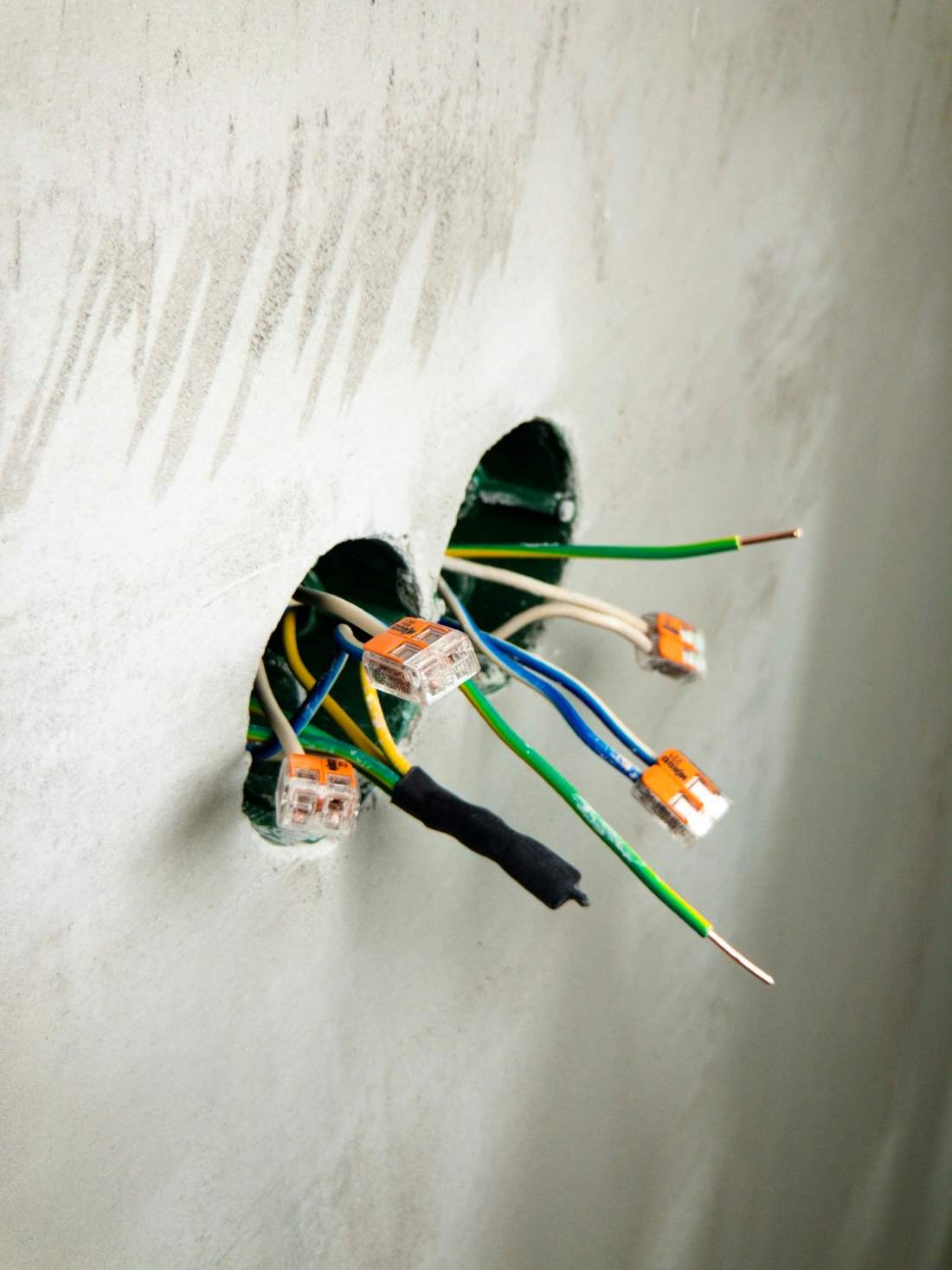 Low-voltage wiring rough-in at a wall box during construction